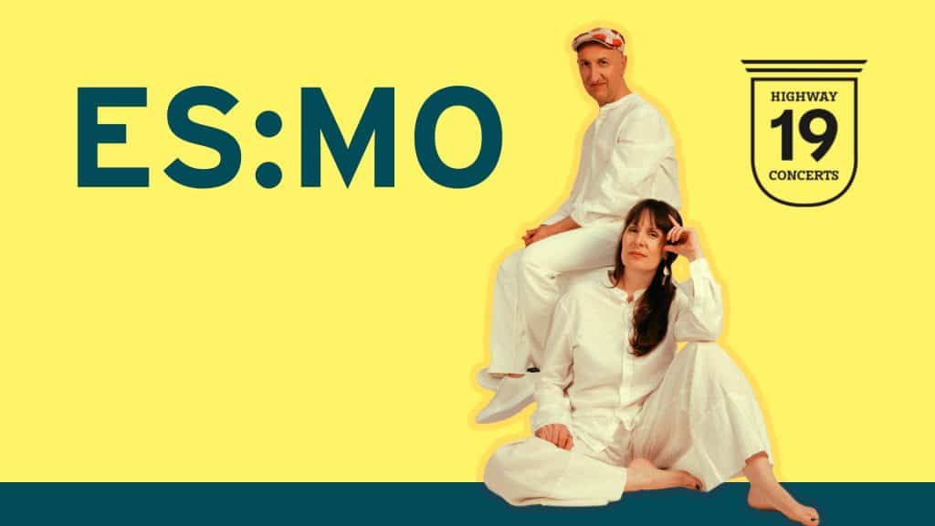 Two people dressed in white outfits pose against a yellow background. One is sitting on the floor, and the other sits on their knee. Large text reads “ES:MO,” and a logo says “Highway 19 Concerts.”.