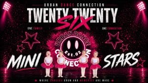 Five young children in pink tutus and white tops stand in a line on stage with "Urban Dance Connection Twenty Twenty Six Mini Stars" written in bold text, surrounded by pink lights, stars, and a logo.