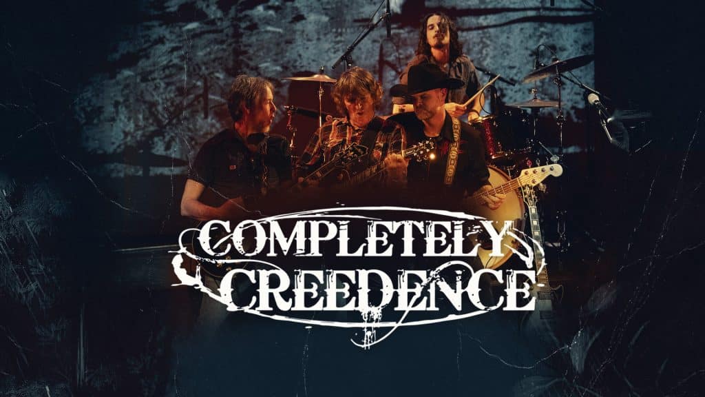 Four musicians perform on stage with instruments under dramatic lighting. The CCR cover band name "Completely Creedence" is boldly displayed in stylized white text across the front of the image.