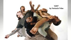 Six dancers from Tentacle Tribe interlock and reach outward in dynamic poses against a white background. The text reads: "'DIRT' by Tentacle Tribe.
