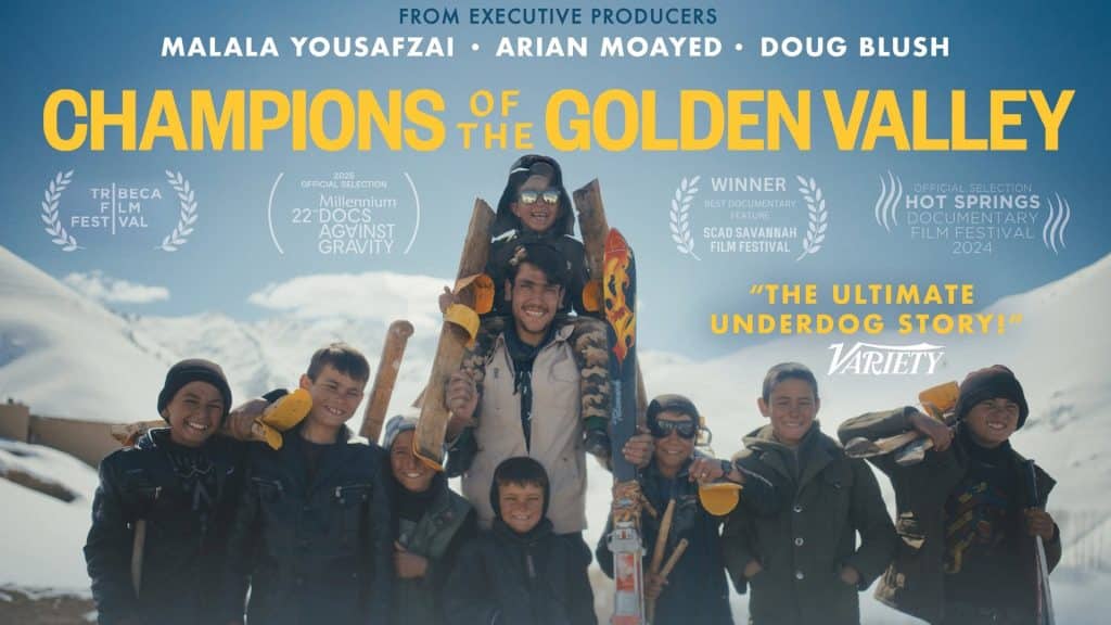 A smiling man and six children holding wooden skis stand together in a snowy mountain landscape. Film festival awards from CRFF and the title “Champions of the Golden Valley” appear over the image.
