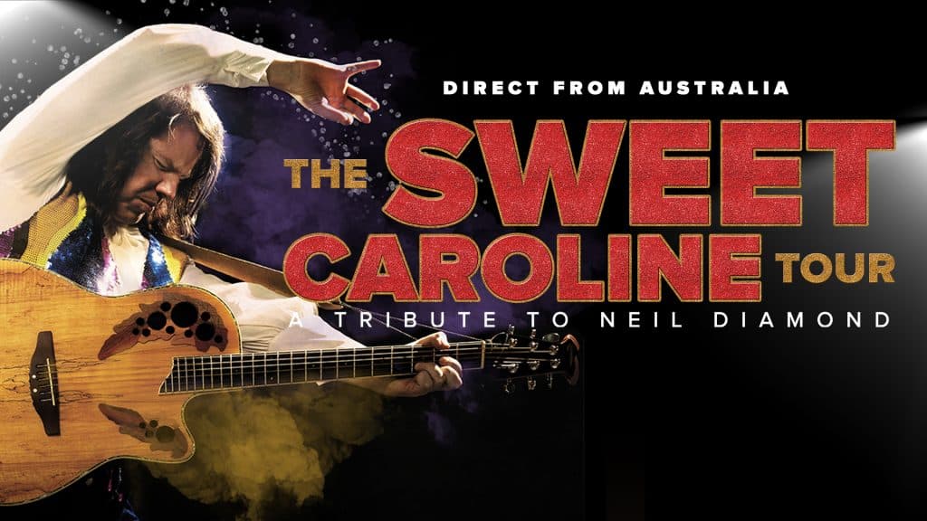 A performer strums a guitar on stage with text: “Direct from Australia. The Sweet Caroline Tour—Tribute to Neil Diamond.” Bold red and yellow letters stand out against a black background, capturing the vibrant energy of this unforgettable Sweet Caroline Tour.
