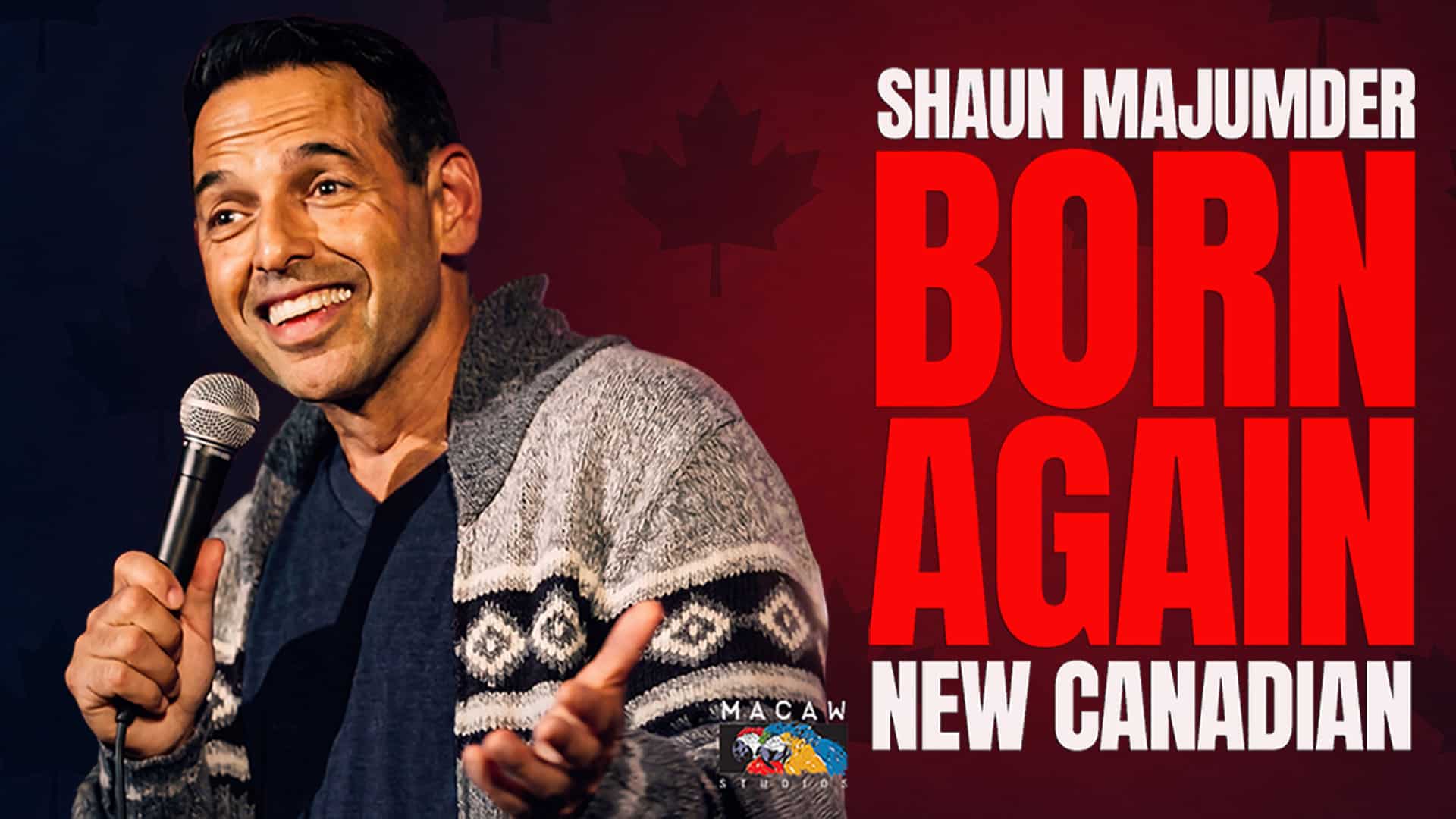 A man holding a microphone smiles while performing stand-up. Large red text beside him reads, “Shaun Majumder Born Again New Canadian” on a dark background with maple leaf outlines, highlighting Shaun Majumder’s acclaimed comedy special “Born Again New Canadian.”.